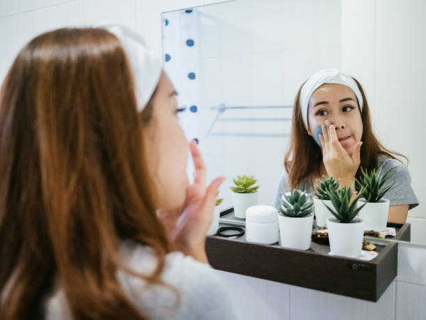 Woman doing face covered in moisturizing mask.