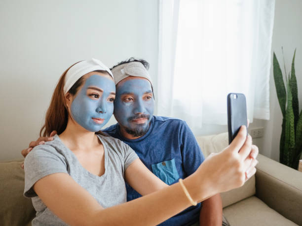istock Happy couple doing facial mask. 1332876400