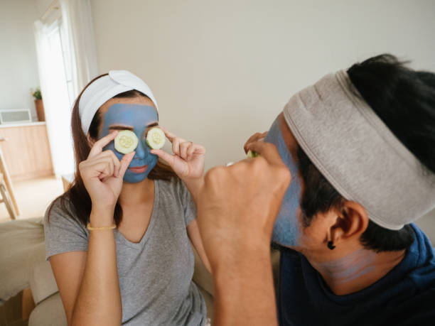 istock Happy couple doing facial mask. 1332876419