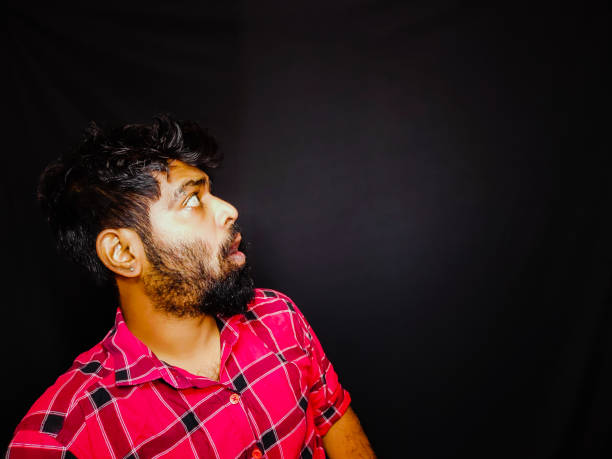 istock Indian bearded guy with red checked short different facial expressions and black background for social media and website banners 1332877513