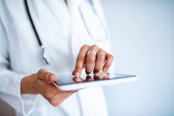 istock Female doctor using her digital tablet in the office. 1332885948