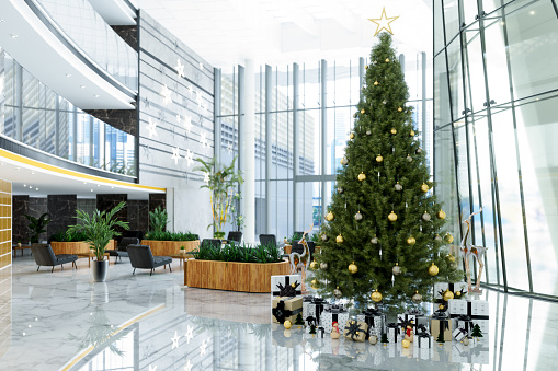 Luxury Hotel Lobby Or Company Lobby With Christmas Tree, Ornaments, Gift Boxes, Black Colored Leather Armchairs And Potted Plants