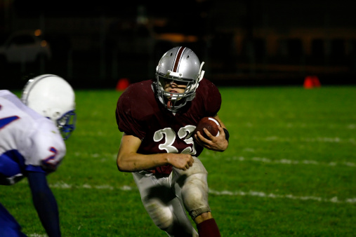 A football running back during a game.