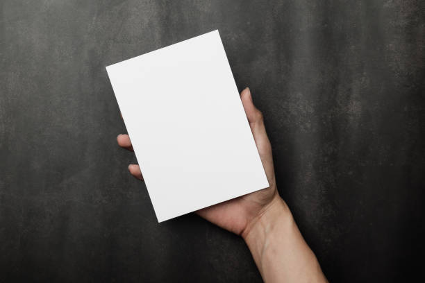 istock Hand holding invitation card mockup, blank greeting card template. Flat lay, top view 1332900280