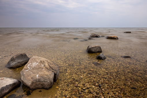 A very large lake with a rocky shore.