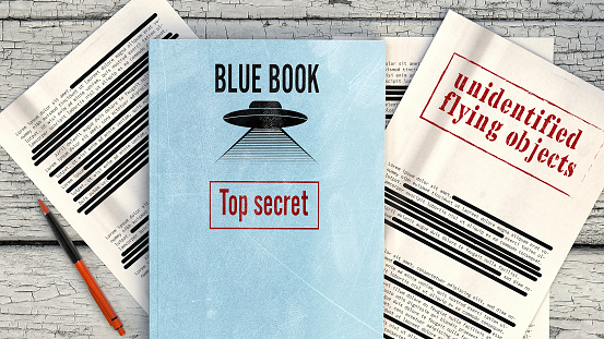 Project Blue Book was the code name for the systematic study of unidentified flying objects by the United States Air Force. Declassified documents and files, top secret files on a table. 3d rendering