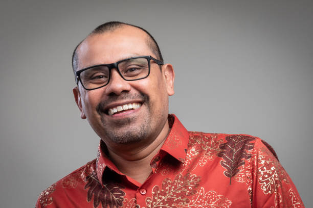 istock Smiling mature hispanic man looking at the camera on gray background 1332919249
