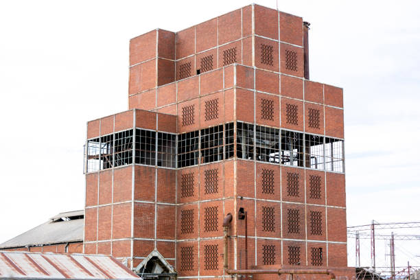 istock Abandoned old gasworks building, white background with copy space 1332922319