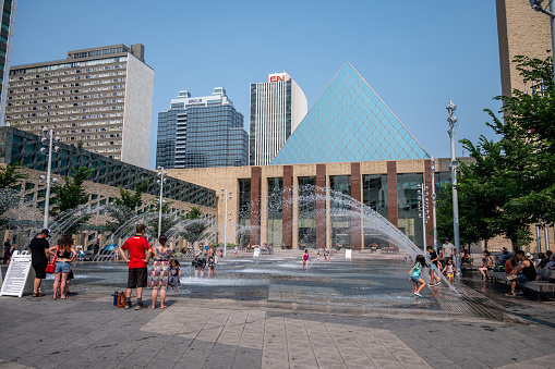 Edmonton, Alberta - July 30, 2021: People playing in the fountains in front of Edmonton city hall.