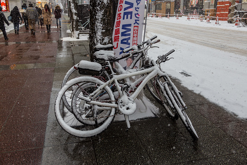 Sapporo, Japan - December 25, 2017: Group of bicycle full with snow during winter season at Sapporo City, Hokkaido, Japan