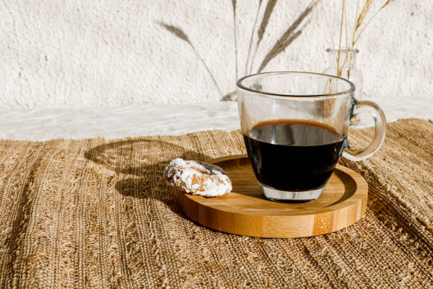 istock Buttery biscuit with icing sugar on top, and a cup of black coffee. Hard light with sharp shadows. Selective focus 1332931581