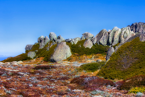 Rocky boulders at the peak of a mountain in Kosciuszko national park of the Snowy Mountains of Australia.