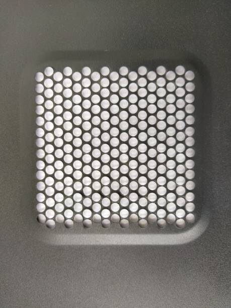 istock ventilation mesh of the computer. Metal surface with round numerous holes 1332934870
