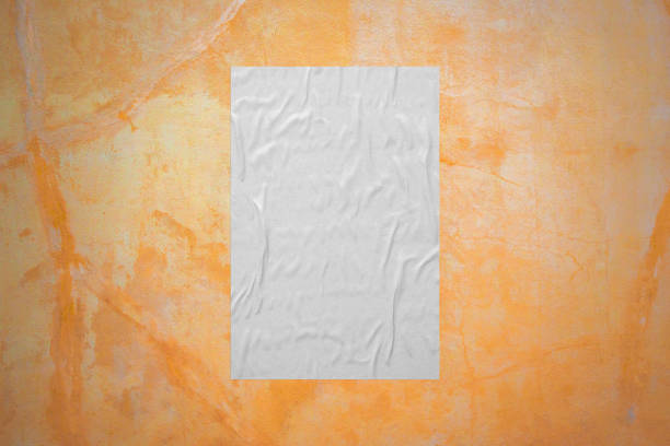 istock Blank white wheatpaste glued paper poster mockup on concrete wall background 1332935388