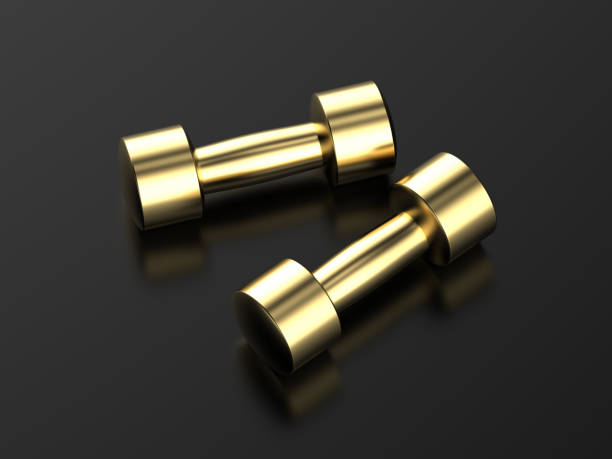 istock golden dumbbells on black background 1332935446