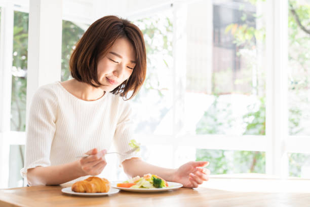 istock attractive asian woman who eats 1332939041