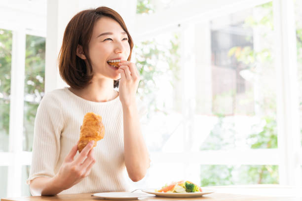 istock attractive asian woman who eats 1332939135