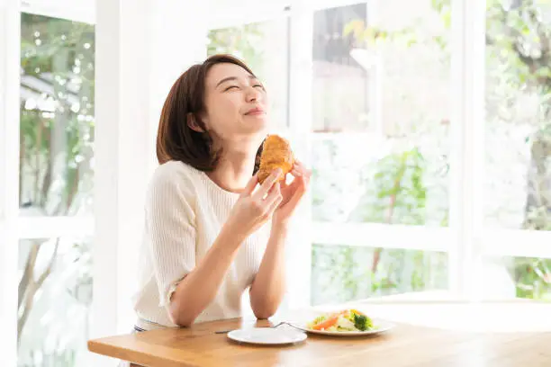 Photo of attractive asian woman who eats