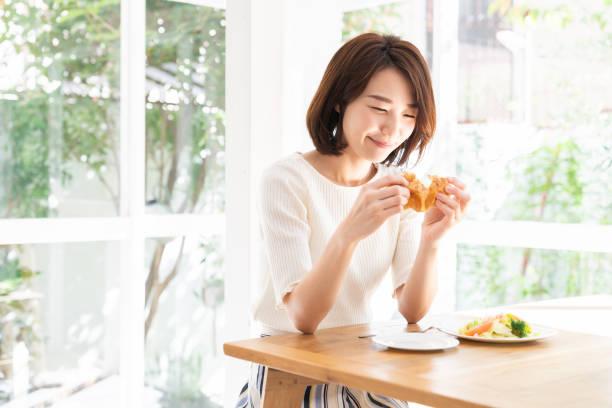 istock attractive asian woman who eats 1332939161
