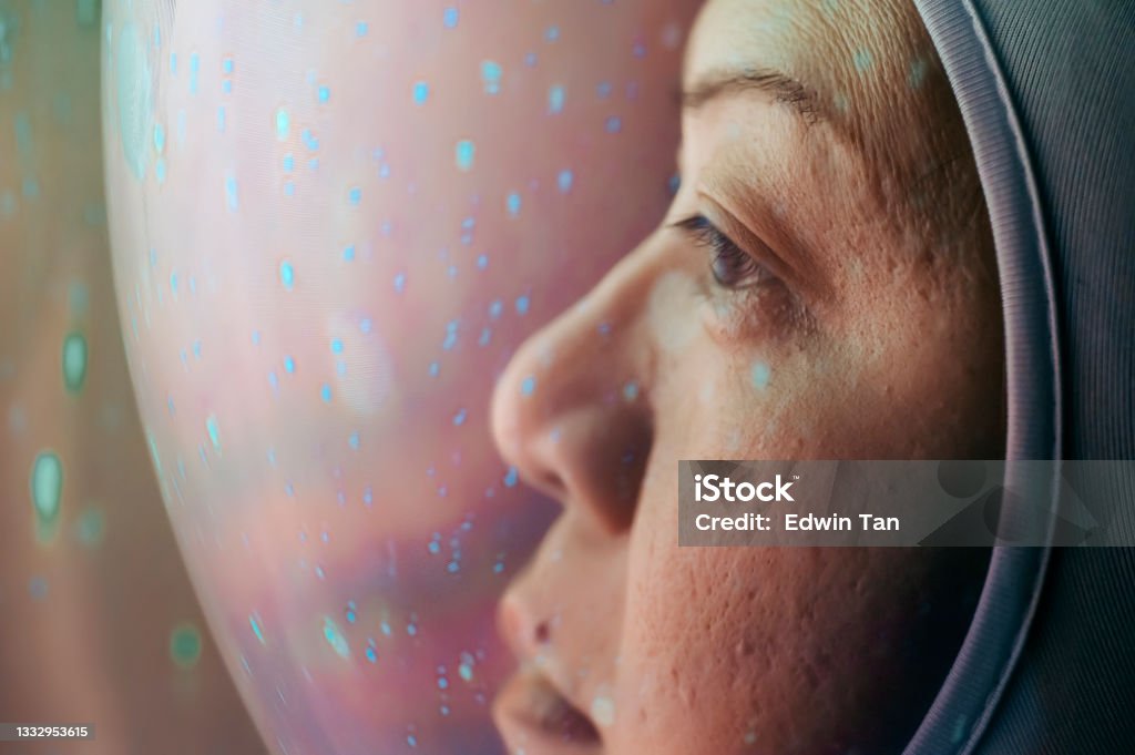 close up Asian chinese mid adult female astronaut looking at a view stardust reflection adventure exploration Asian chinese mid adult female astronaut looking at a view stardust reflection adventure exploration Astronaut Stock Photo