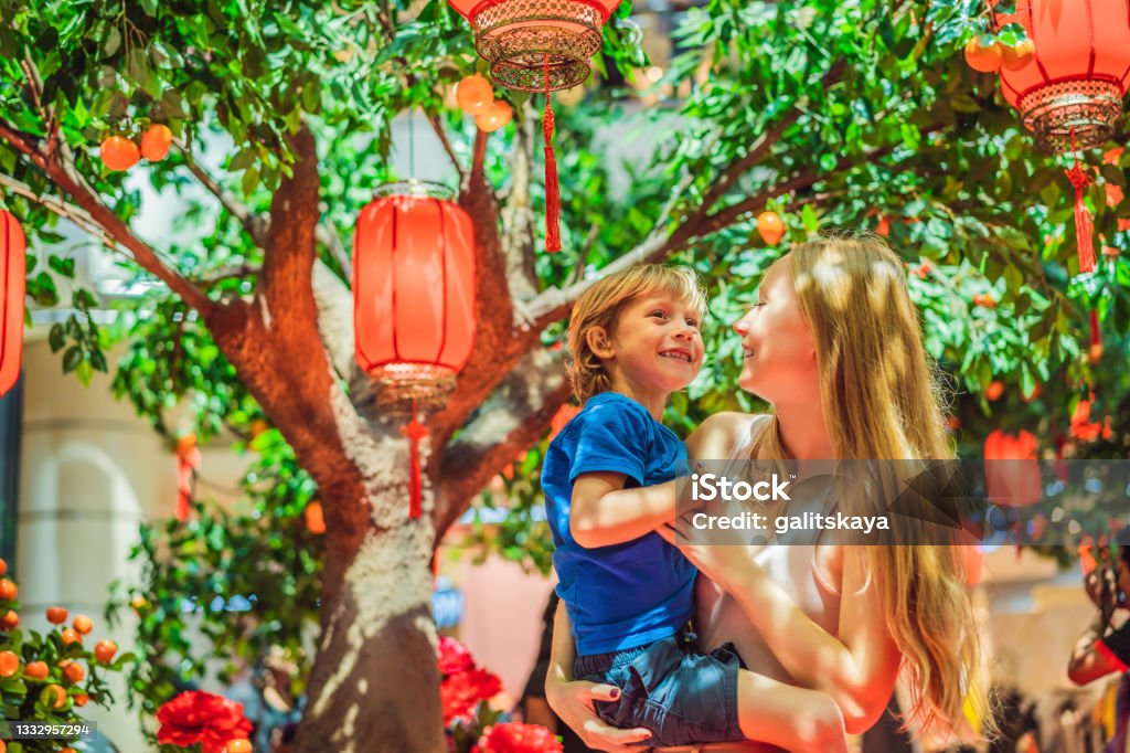 Mom and son celebrate Chinese New Year look at Chinese red lanterns Mom and son celebrate Chinese New Year look at Chinese red lanterns. Family Stock Photo
