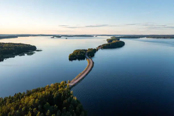 Photo of Pulkkilanharju ridge road and calm Päijänne lake in summer in Finland.