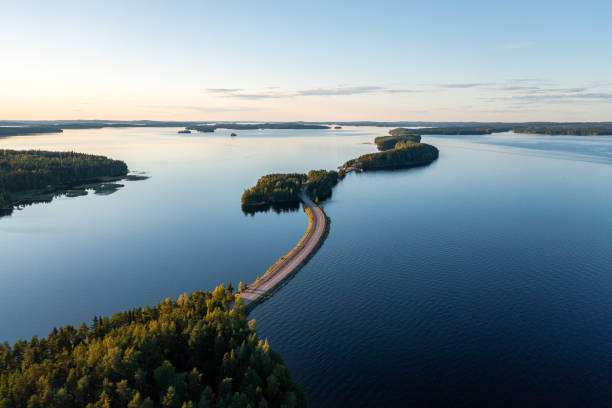 pulkkilanharju ridge road and calm päijänne lake in summer in finland. - blue fin imagens e fotografias de stock