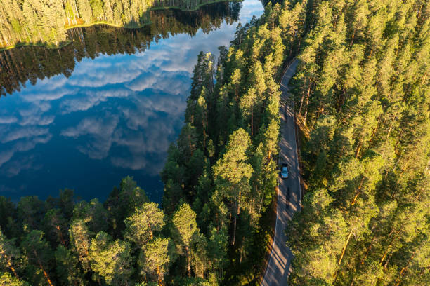 Aerial view of ridge road forest and lake in the morning Aerial view of ridge road forest and lake in the morning etela savo finland stock pictures, royalty-free photos & images