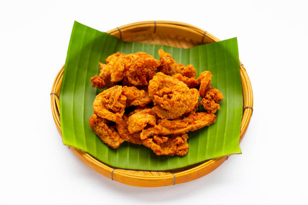 istock Fried crispy pork belly recipe in bamboo basket on white background. 1332959582