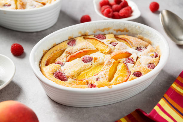 istock Traditional french pie clafoutis with fresh summer peaches and raspberry 1332964465