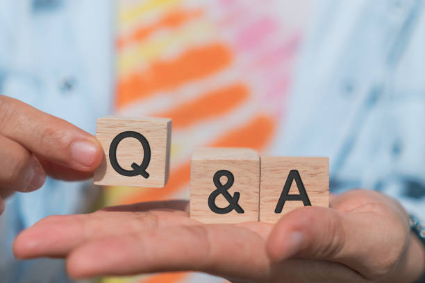 istock Q and A alphabet on wooden cube in hand hold with background. Question and answer meaning concept. 1332965244