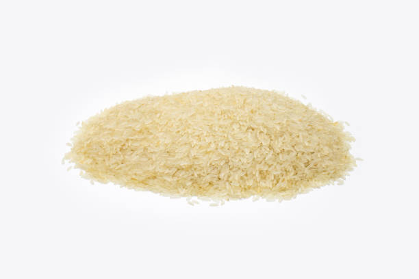 istock Uncooked dry rice pile on an isolated white background 1332967680