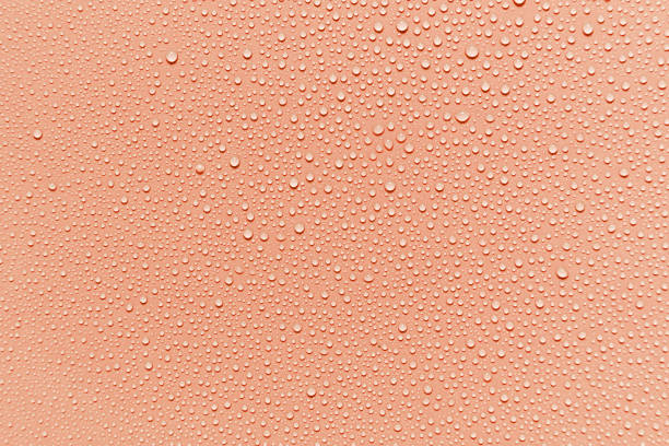 istock a macro of some water drops on a red background 1332968537