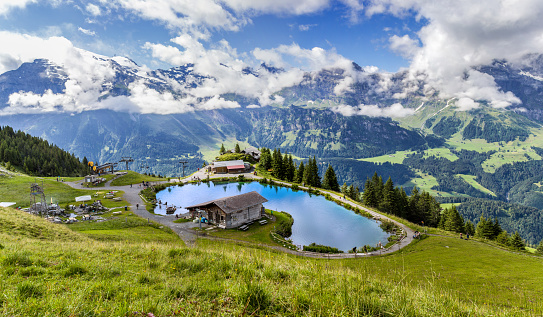 Brunni, Switzerland - August 06. 2021: Panorama of the mountain lake Haerzlisee above the Engelberg in Titlis region, which offers diverse outdoor activities, such as hiking, climbing, skiing.