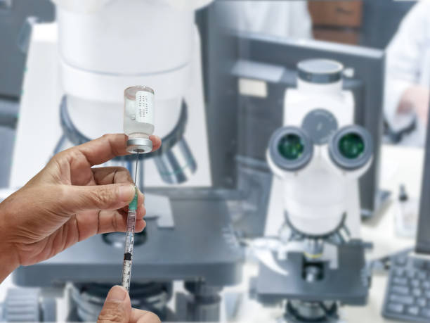 istock holds a syringe with a liquid vaccine in development laboratory 1332973045