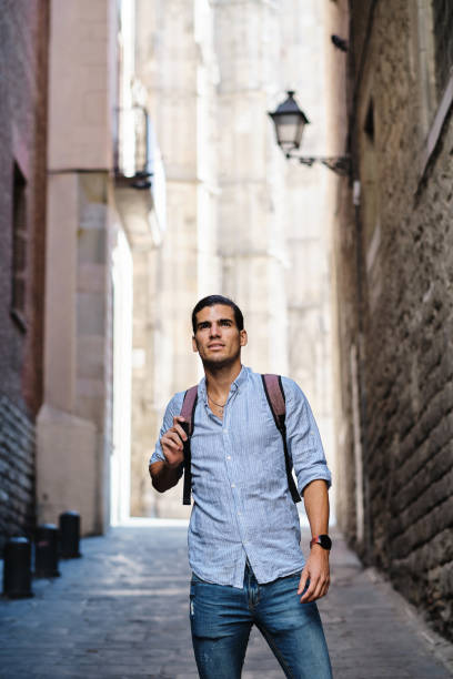 istock young tourist with backpack at gothic quarter in Barcelona 1332977397