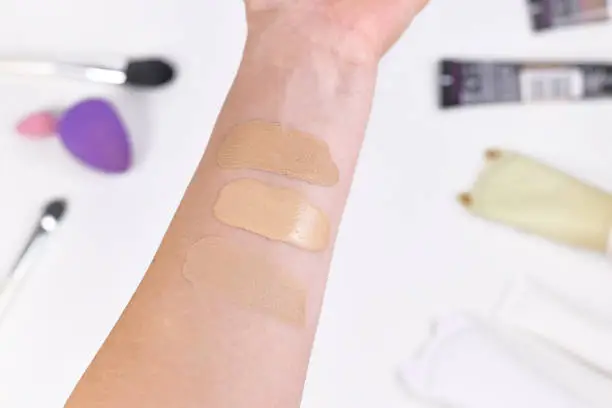 Swatches of foundation on lower arm to find right skin tone shade