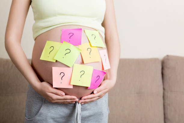 istock Pregnant woman belly with question mark. Pregnancy and thinking problem 1332983253