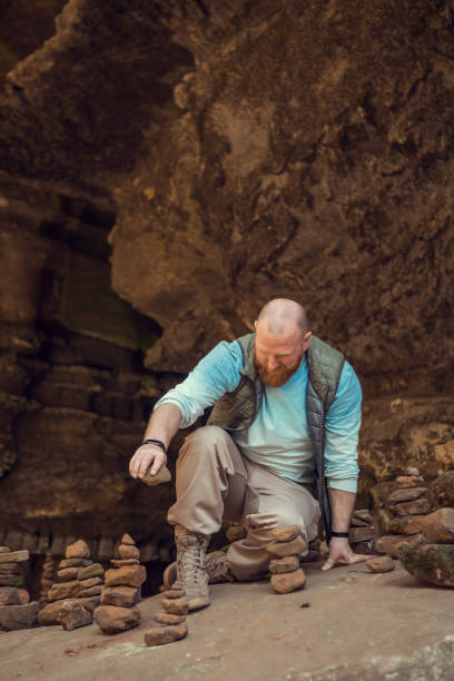 istock Redhead man practicing yoga in the nature 1332983413