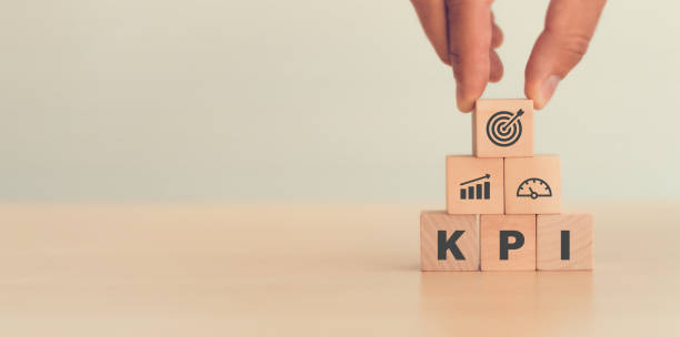 istock KPI, Key Performance Indicator. Businessman holds cube with KPI icon; business goals, performance results and indicators . For business planning and measure success, target achievement. Copy space. 1332984173