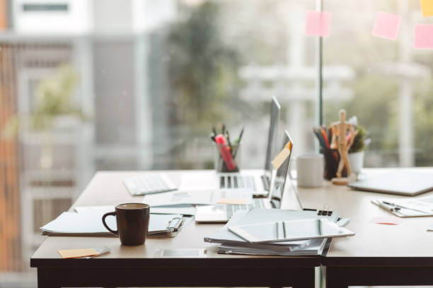 istock Close up coffee cup. Work desk where documents and equipment are placed. at the modern office. 1332985423
