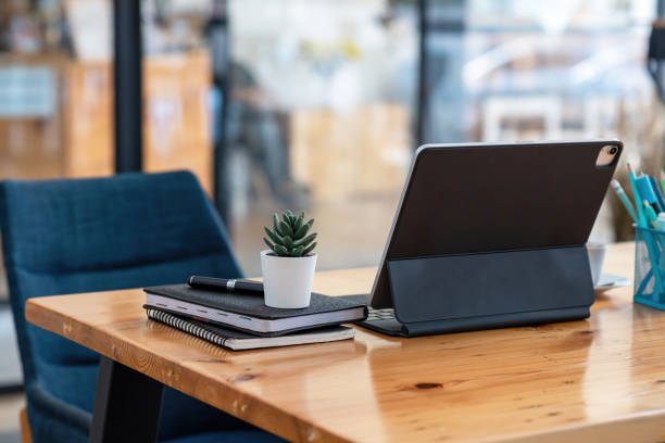 istock Back view of tablet placed on desk in office. 1332985428