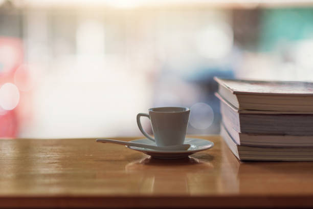 istock Hot coffee mug and notebook on wooden table with blurred back. 1332985586