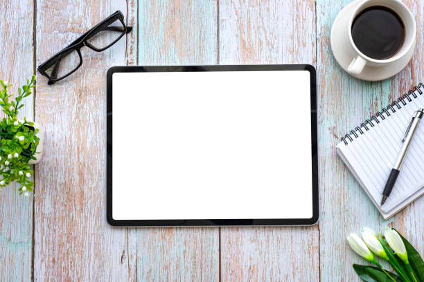 Top view of space  creative working  table wooden and tablet blank white screen is placed. Mock up.