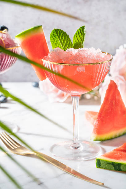 istock Watermelon granita glass cup on marble table with watermelon slices 1332988031