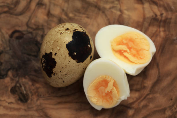 small boiled speckled quail eggs peeled and halved small boiled speckled quail eggs peeled and halved coturnix quail stock pictures, royalty-free photos & images