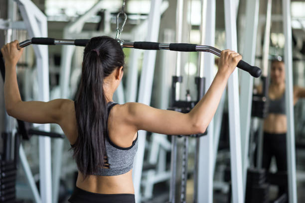 istock Fit woman pump back muscles exercise in gym 1332988308