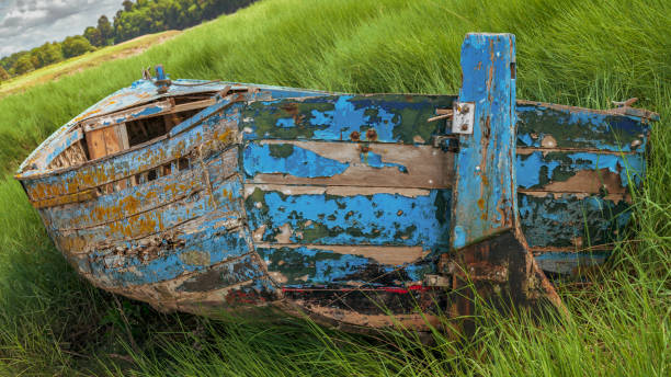 A decayed boat near the shore of the River Avon in the Pill Foreshore in Pill, North Somerset, England, UK