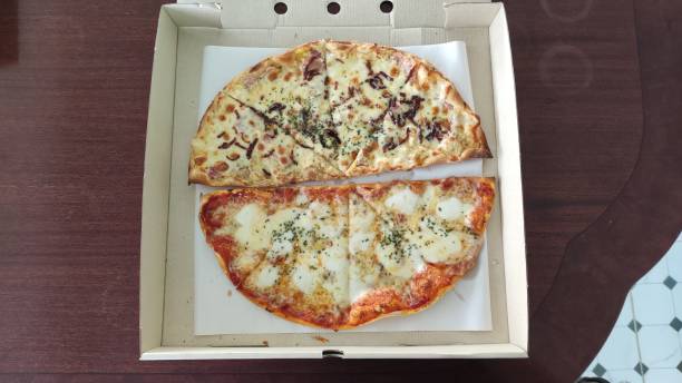 istock Two flavors of pizza in one pan 1332989479