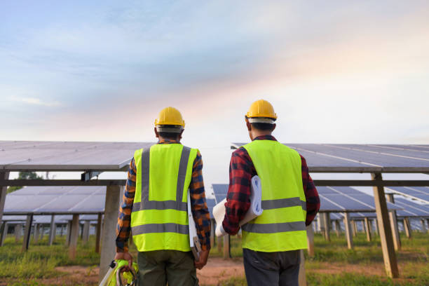 istock solar power station,Solar panels with technician 1332989564